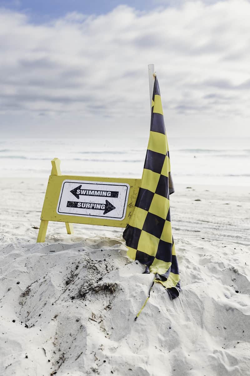 checkered flag at the beach means surfing - beach safety tips for parents