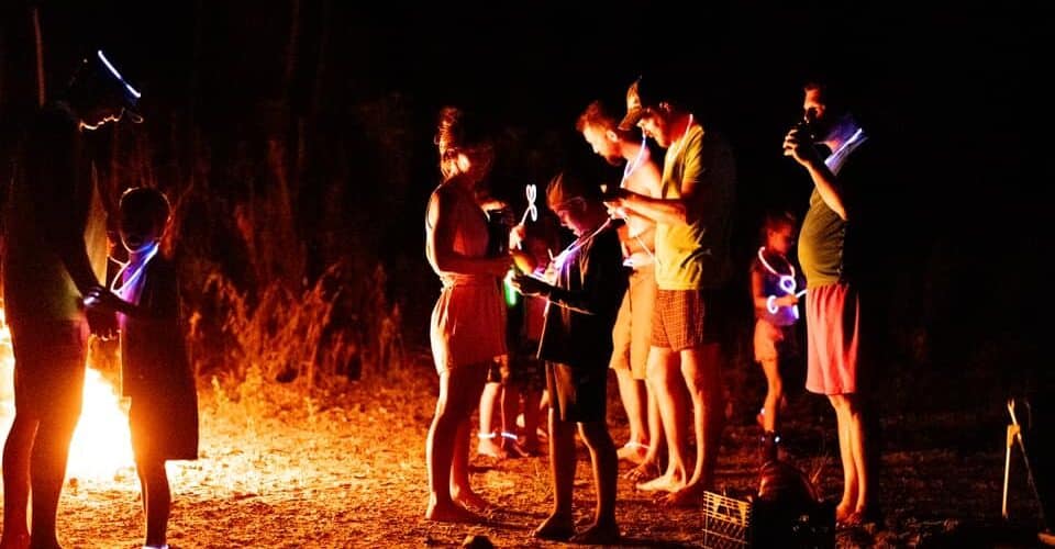 a family outdoors at night around a bonfire