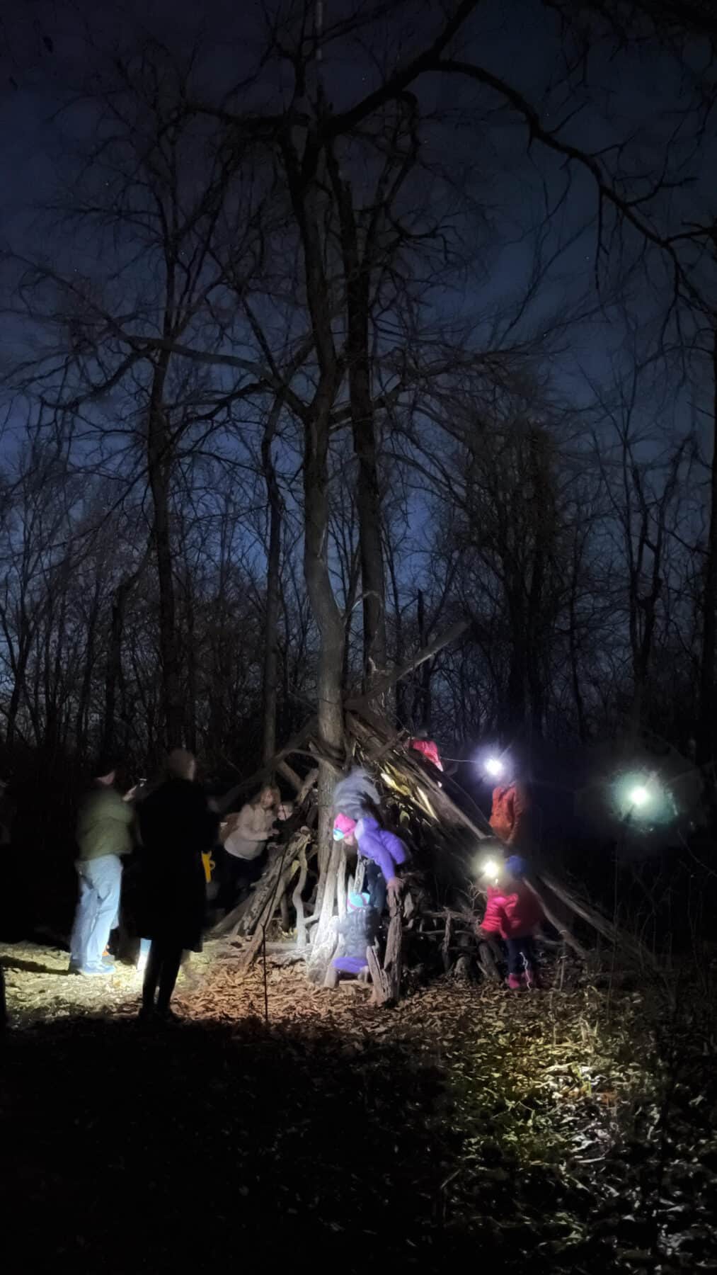 kids climbing at night wearing headlamps