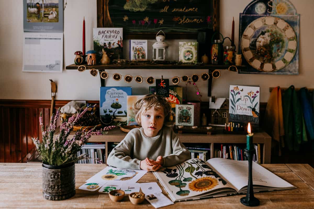 Child studying seeds during homeschool lesson.