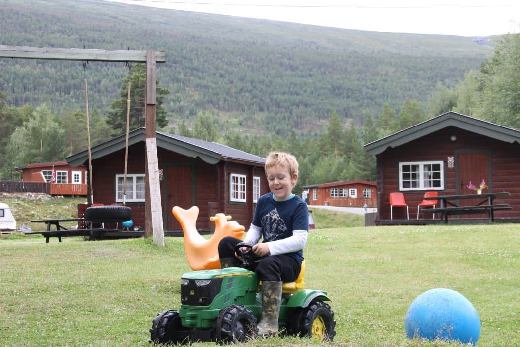 Riding a toy tractor