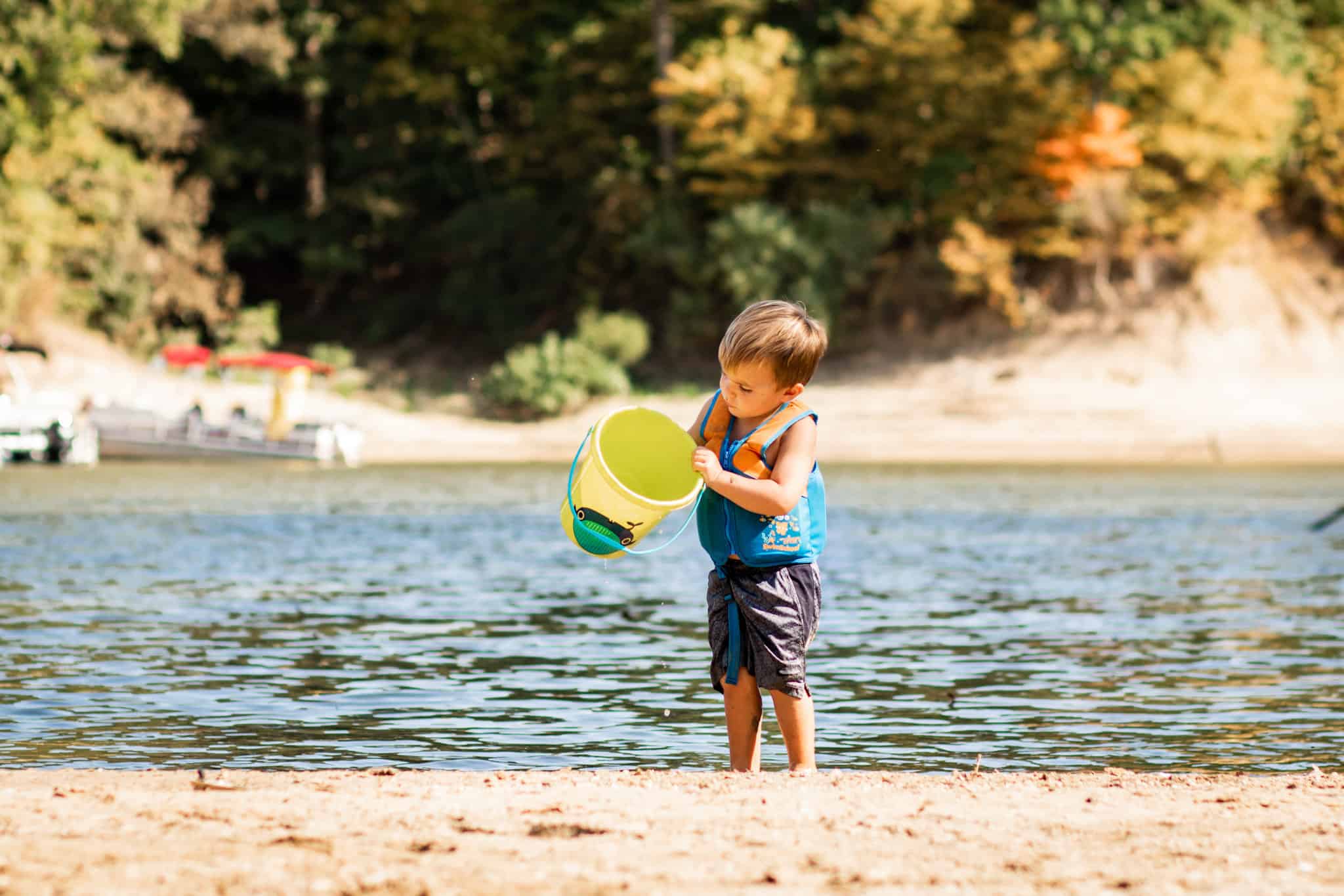 Child playing on the beach with life vest on - best overall life jacket for kids