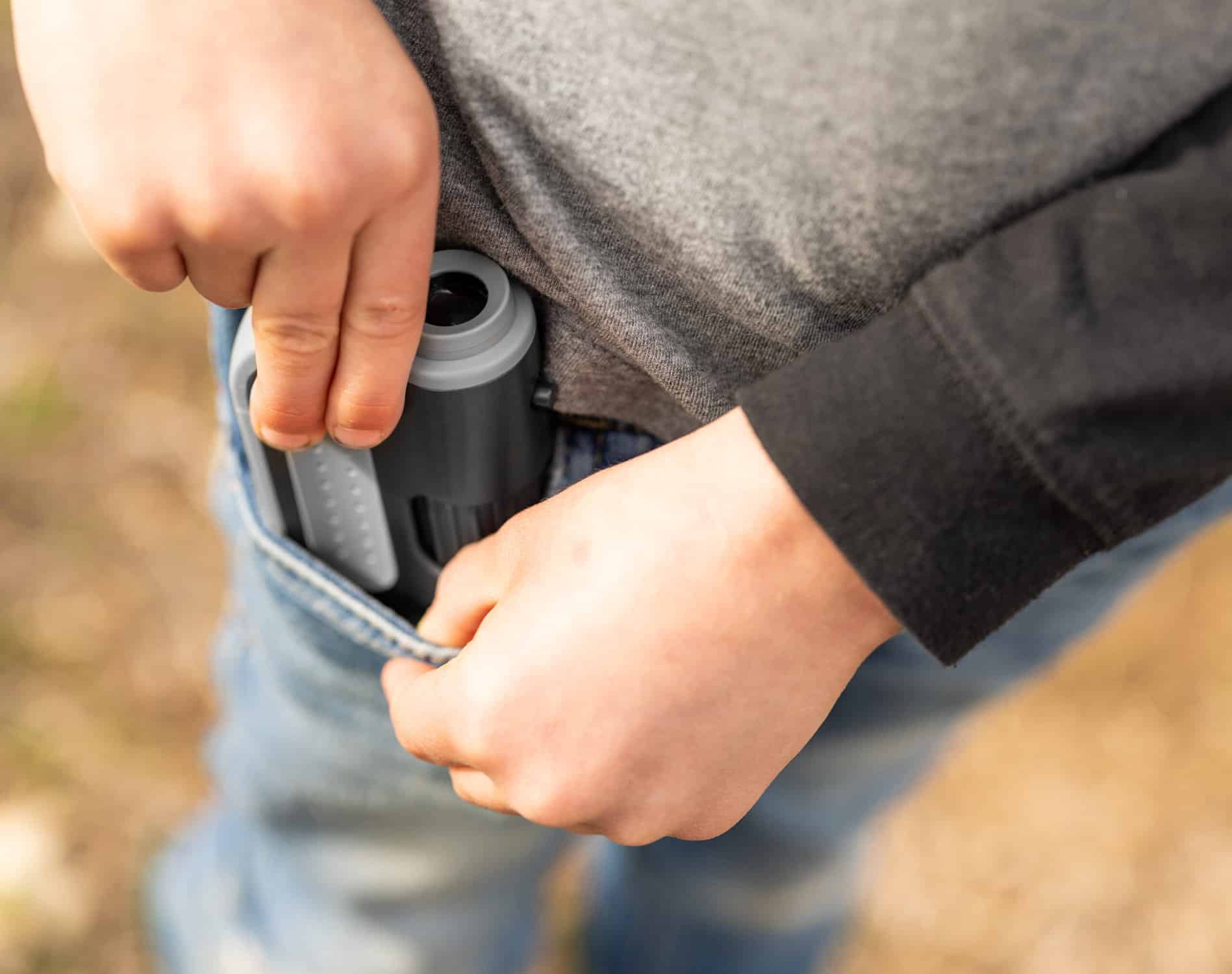 child putting microscope in pocket