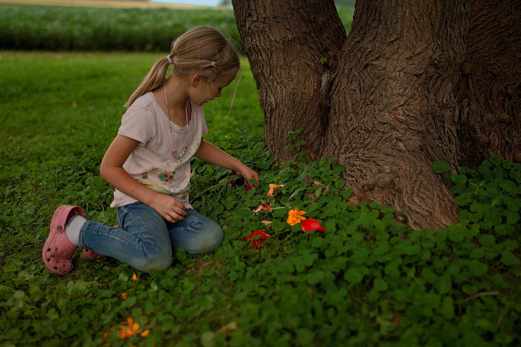 girl playing with flowers