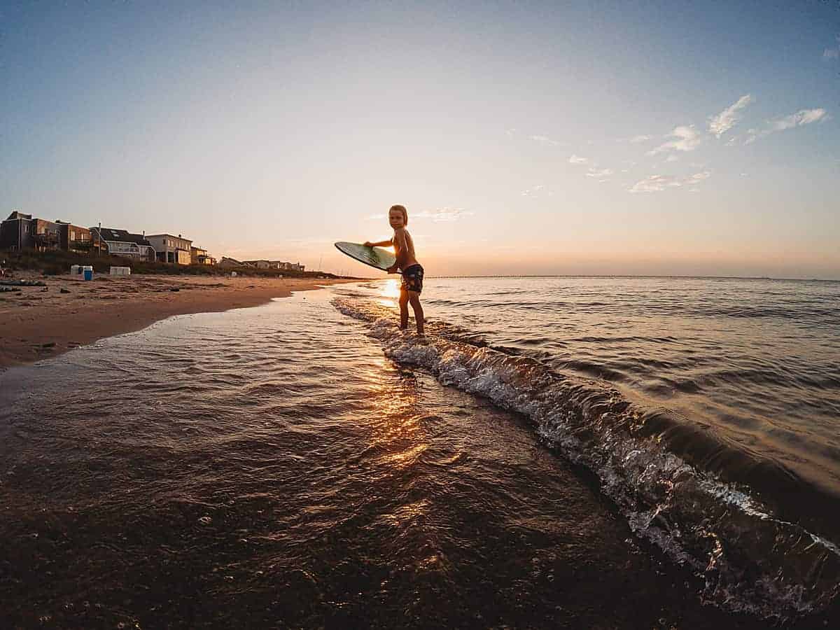 kids skim boarding at the beach - favorite water activities for kids