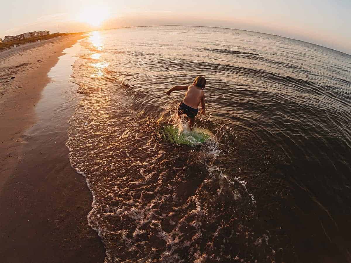 kids skim boarding at the beach - favorite water activities for kids