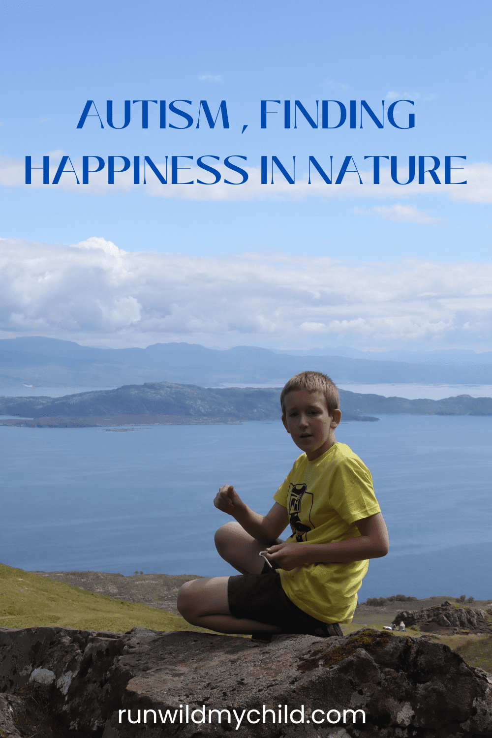 a boy sitting on a rock