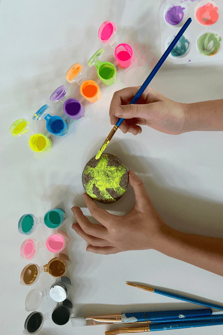 Child Painting a Sunshine on a rock