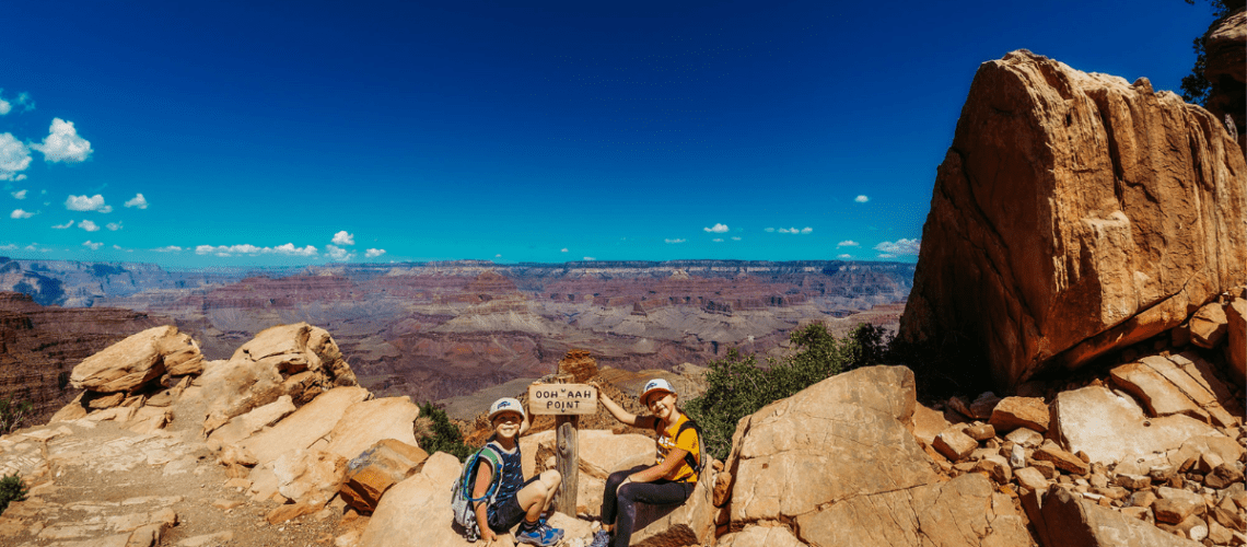 two kids at the trail sign for Oooh Ahh point in the Grand Canyon National Park