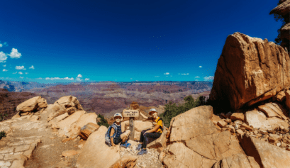 two kids at the trail sign for Oooh Ahh point in the Grand Canyon National Park