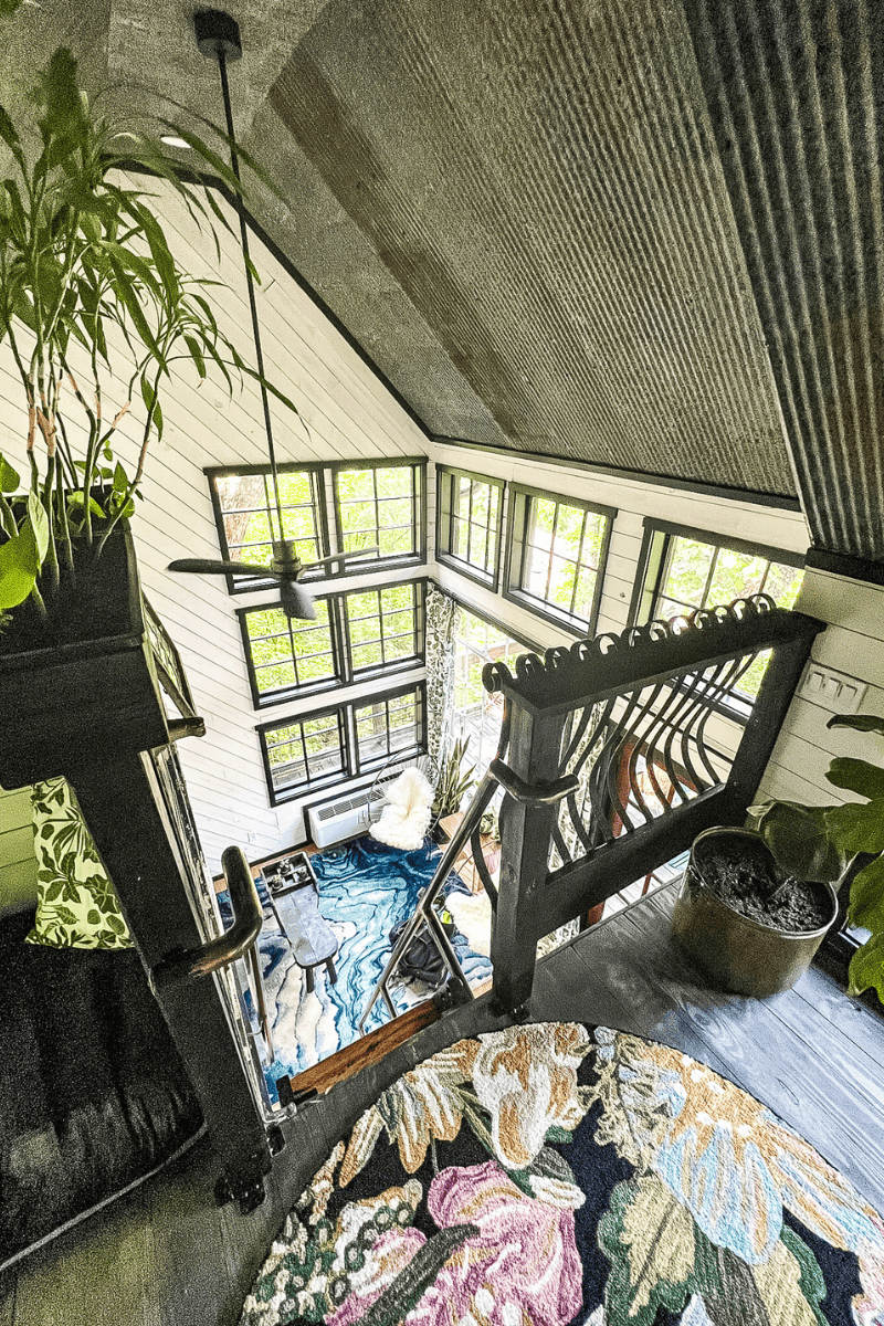 Interior shot of a luxury treehouse at Treetop Hideaways taken from the loft above