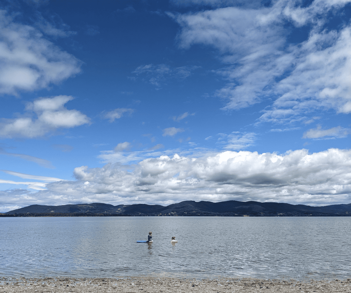 Two kids playing in the ocean. 